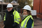 Ruth in a hard hat and reflective jacket on a construction site